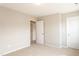 A bright bedroom with beige carpet, white trim, and a white closet door at 296 Johnson Ridge Way, Four Oaks, NC 27524