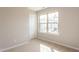 Carpeted bedroom with neutral walls and a large window at 296 Johnson Ridge Way, Four Oaks, NC 27524