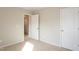 Cozy carpeted bedroom with an open doorway and two closets, perfect for creating a personalized space at 296 Johnson Ridge Way, Four Oaks, NC 27524