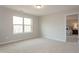 Bright, carpeted bedroom with a large window and neutral walls, offering a tranquil and inviting space at 296 Johnson Ridge Way, Four Oaks, NC 27524
