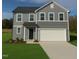 Charming two-story home featuring a two-car garage and manicured lawn at 296 Johnson Ridge Way, Four Oaks, NC 27524