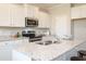 Bright kitchen featuring granite countertops, stainless steel appliances, and ample storage at 296 Johnson Ridge Way, Four Oaks, NC 27524