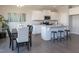 Modern kitchen featuring granite countertops, stainless appliances, island, and dining area at 296 Johnson Ridge Way, Four Oaks, NC 27524