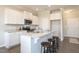 Open kitchen with granite counters, stainless appliances, and seating at the island at 296 Johnson Ridge Way, Four Oaks, NC 27524
