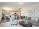 Open concept living room with a view of the modern kitchen and dining area, featuring stylish decor at 296 Johnson Ridge Way, Four Oaks, NC 27524