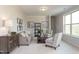 Cozy living room featuring neutral tones, comfortable seating, and decorative accents, creating a relaxing atmosphere at 296 Johnson Ridge Way, Four Oaks, NC 27524