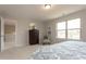 Spacious main bedroom with a large window, dresser, and chair creating an inviting and relaxing retreat at 296 Johnson Ridge Way, Four Oaks, NC 27524