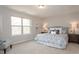 Comfortable main bedroom with a patterned bedspread, side tables, and a window offering ample natural light at 296 Johnson Ridge Way, Four Oaks, NC 27524