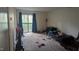 Condo bedroom with balcony, tan carpet, and furnishings at 311 Ashley Forest Rd # Bldg E, Chapel Hill, NC 27514