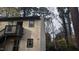 Two-story condo with light beige siding, dark trim, and a balcony over the front door entrance at 311 Ashley Forest Rd # Bldg E, Chapel Hill, NC 27514