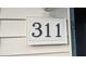 Close up of the address number '311' on a condo building, indicating the unit number within the complex at 311 Ashley Forest Rd # Bldg E, Chapel Hill, NC 27514