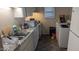 Condo kitchen view includes sink, white appliances, and washer and dryer in the same space at 311 Ashley Forest Rd # Bldg E, Chapel Hill, NC 27514