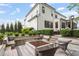 Spacious backyard featuring a stone fire pit, built-in seating, and lush landscaping, perfect for outdoor entertaining at 3160 Mantle Ridge Dr, Apex, NC 27502