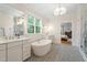 Stylish bathroom features patterned tile flooring, a soaking tub, and bright lighting at 3160 Mantle Ridge Dr, Apex, NC 27502