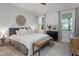 Comfortable bedroom features a round mirror and stylish dresser that compliments the neutral bedding at 3160 Mantle Ridge Dr, Apex, NC 27502