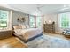 Bright bedroom with light hardwood floors, paneled accent wall, and plenty of natural light at 3160 Mantle Ridge Dr, Apex, NC 27502