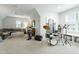 Spacious bonus room featuring a drum kit, large sectional sofa, and built-in storage, perfect for recreation at 3160 Mantle Ridge Dr, Apex, NC 27502