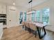 Bright dining room boasts a modern chandelier, a farmhouse table, and lots of natural light at 3160 Mantle Ridge Dr, Apex, NC 27502