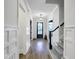 Elegant entryway with beautiful hardwood floors, white trim, and a view of the front door at 3160 Mantle Ridge Dr, Apex, NC 27502
