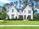 Stunning white brick home with meticulous landscaping, mature trees, and charming curb appeal at 3160 Mantle Ridge Dr, Apex, NC 27502