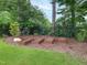 Beautiful garden boxes sit in the landscaped mulch at 3160 Mantle Ridge Dr, Apex, NC 27502