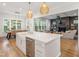 Bright and open kitchen with a large island, stainless steel appliances, and seamless flow to living spaces at 3160 Mantle Ridge Dr, Apex, NC 27502