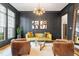 Sophisticated living room with modern decor, a unique glass table, and dark paneled walls at 3160 Mantle Ridge Dr, Apex, NC 27502
