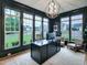 Stylish office with large windows, dark walls, contemporary lighting, and hardwood floors at 3160 Mantle Ridge Dr, Apex, NC 27502