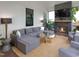 Inviting screened-in patio featuring a stone fireplace, comfortable seating, and a cozy atmosphere at 3160 Mantle Ridge Dr, Apex, NC 27502