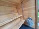 Inside sauna showing wooden benches and rack of hot stones at 3160 Mantle Ridge Dr, Apex, NC 27502