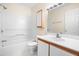 Bathroom featuring a wood-trimmed vanity and sink, toilet, and tiled shower at 320 Summerwalk Cir, Chapel Hill, NC 27517