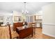 Open concept dining room with wood floors, modern chandelier, and seamless flow to the kitchen at 320 Summerwalk Cir, Chapel Hill, NC 27517