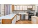 Modern kitchen with quartz countertops, stainless steel appliances, and ample cabinet space at 320 Summerwalk Cir, Chapel Hill, NC 27517