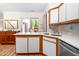 Well-lit kitchen with quartz countertops, stainless steel appliances, and backyard view at 320 Summerwalk Cir, Chapel Hill, NC 27517