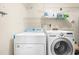 Laundry area with side-by-side washer and dryer and shelving at 320 Summerwalk Cir, Chapel Hill, NC 27517