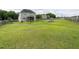 Expansive backyard with lush grass, a wooden fence, playset, and deck, perfect for outdoor activities at 33 Northlodge Ct, Wendell, NC 27591
