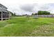 Large fenced backyard features mature trees, a playset, and a trampoline at 33 Northlodge Ct, Wendell, NC 27591