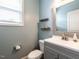 Cozy bathroom with a gray vanity, white countertop, and a decorative mirror at 33 Northlodge Ct, Wendell, NC 27591