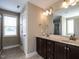 Bathroom featuring a double sink vanity with dark cabinets and modern fixtures, and tiled floors at 33 Northlodge Ct, Wendell, NC 27591