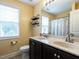 Well-lit bathroom features a double vanity with dark cabinets and a shower/tub combination at 33 Northlodge Ct, Wendell, NC 27591