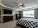Serene bedroom with tray ceiling, ceiling fan and abundant light streaming in from a large window at 33 Northlodge Ct, Wendell, NC 27591