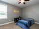 This bedroom has a neutral tone with a comfy bed, bookshelf, and lots of natural light at 33 Northlodge Ct, Wendell, NC 27591