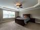 Comfortable bedroom with a ceiling fan and a window, with neutral walls and carpet flooring at 33 Northlodge Ct, Wendell, NC 27591