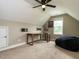 Spacious bonus room under vaulted ceiling with desk, mounted TV, and beanbag chair at 33 Northlodge Ct, Wendell, NC 27591