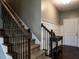 Welcoming foyer featuring a staircase with decorative iron railings and stylish wainscoting at 33 Northlodge Ct, Wendell, NC 27591