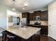 Modern kitchen with granite countertops, stainless steel appliances, dark cabinetry, and pendant lighting at 33 Northlodge Ct, Wendell, NC 27591