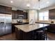 Spacious kitchen with a granite island, stainless steel appliances, dark cabinets, and a tiled backsplash at 33 Northlodge Ct, Wendell, NC 27591