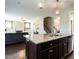 Open-concept kitchen with granite island and stainless dishwasher in view of a living room with a fireplace at 33 Northlodge Ct, Wendell, NC 27591