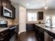 Well-equipped kitchen with stainless steel appliances, granite countertops, and dark cabinetry at 33 Northlodge Ct, Wendell, NC 27591