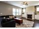 Cozy living room with a fireplace, built-in shelves, hardwood floors, and natural light at 33 Northlodge Ct, Wendell, NC 27591